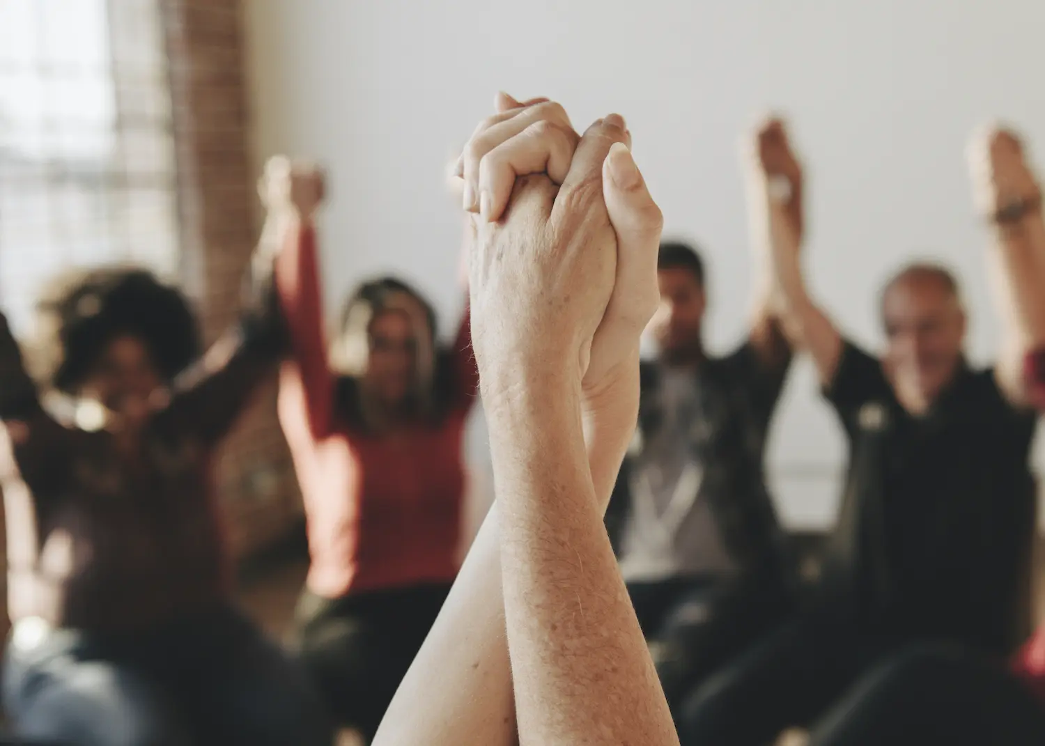 people holding hands in a circle