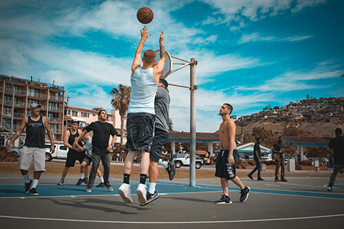 men playing basketball outdoors