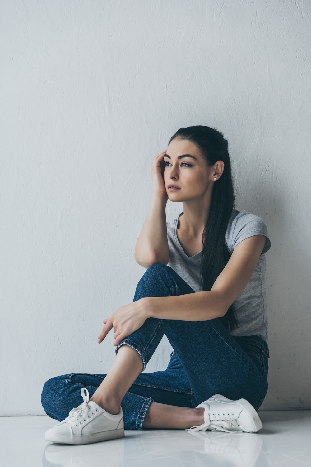 Young woman sitting in chair looking off into the distance